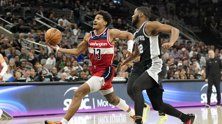 Nov 13, 2024; San Antonio, Texas, USA; Washington Wizards guard Jordan Poole (13) drives to the basket past San Antonio Spurs guard Malaki Branham (22) during the second half at Frost Bank Center. Mandatory Credit: Scott Wachter-Imagn Images