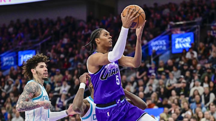 Jan 10, 2026; Salt Lake City, Utah, USA; Utah Jazz forward Cody Williams (5) leaps toward the basket ahead of Charlotte Hornets forward Moussa Diabaté (14) during the first half at Delta Center. Mandatory Credit: Peter Creveling-Imagn Images