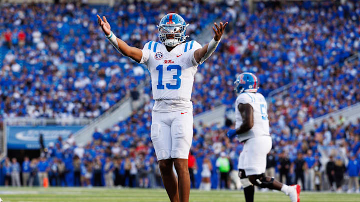 Sep 6, 2025; Lexington, Kentucky, USA; Mississippi Rebels quarterback Austin Simmons (13) celebrates after scoring a touchdown during the fourth quarter against the Kentucky Wildcats at Kroger Field. Mandatory Credit: Jordan Prather-Imagn Images