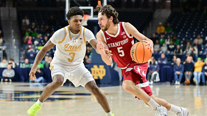 Mar 5, 2025; South Bend, Indiana, USA; Stanford Cardinal guard Benny Gealer (5) drives to the basket as Notre Dame Fighting Irish guard Markus Burton (3) defends in the second half at the Purcell Pavilion. Mandatory Credit: Matt Cashore-Imagn Images