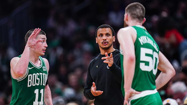 Apr 12, 2024; Boston, Massachusetts, USA; Boston Celtics head coach Joe Mazzulla talks with guard Svi Mykhailiuk (50) and guard Payton Pritchard (11) from the sideline as they take on the Charlotte Hornets at TD Garden. Mandatory Credit: David Butler II-Imagn Images