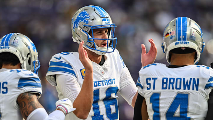 Detroit Lions quarterback Jared Goff warms up with wide receiver Amon-Ra St. Brown before the game against the Minnesota Vikings.
