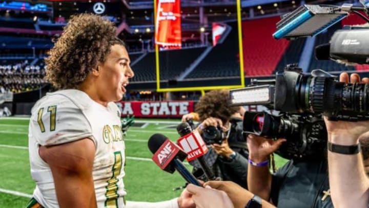 Grayson senior quarterback Travis Burgess, a North Carolina commit, threw for three touchdowns and rushed for another as the No. 1 Rams dominated No. 7 Collins Hill in a Georgia high school season opener.