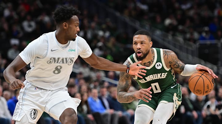 Mar 5, 2025; Milwaukee, Wisconsin, USA; Milwaukee Bucks guard Damian Lillard (0) drives for the basket against Dallas Mavericks forward Olivier-Maxence Prosper (8) in the second quarter at Fiserv Forum. Mandatory Credit: Benny Sieu-Imagn Images Mar 5, 2025; Milwaukee, Wisconsin, USA; Milwaukee Bucks guard Damian Lillard (0) drives for the basket against Dallas Mavericks forward Olivier-Maxence Prosper (8) in the second quarter at Fiserv Forum. Mandatory Credit: Benny Sieu-Imagn Images
