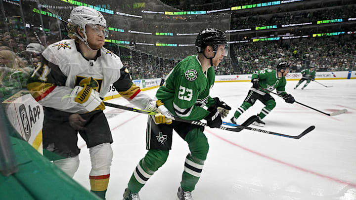 May 5, 2024; Dallas, Texas, USA; Vegas Golden Knights center William Karlsson (71) and Dallas Stars defenseman Esa Lindell (23) chase the puck in the Stars zone during the third period in game seven of the first round of the 2024 Stanley Cup Playoffs at American Airlines Center. Mandatory Credit: Jerome Miron-Imagn Images