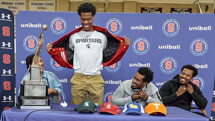 Stepinac High School basketball star Jasiah Jervis unveils a Michigan State University t-shirt as he announces which college he will be attending and playing basketball at during a ceremony at Stepinac High School in White Plains Nov. 5, 2025. With Jasiah was his mother Falana, his father Rhodes, and brother Jafari.