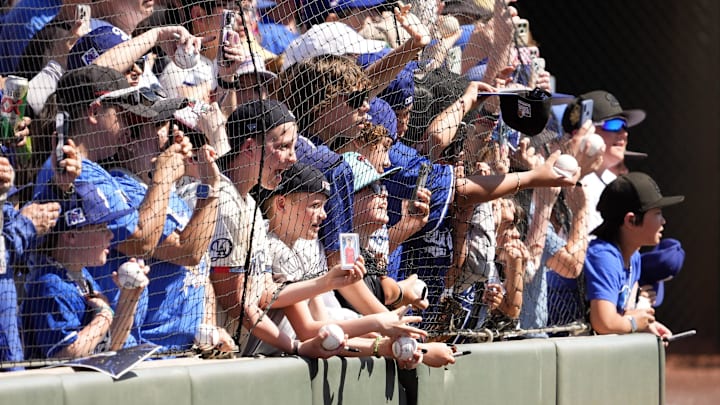 Los Angeles Dodgers fans watch Shohei Ohtani walk to the dugout to play the Arizona Diamondbacks during a spring training game at Camelback Ranch-Glendale in Phoenix.