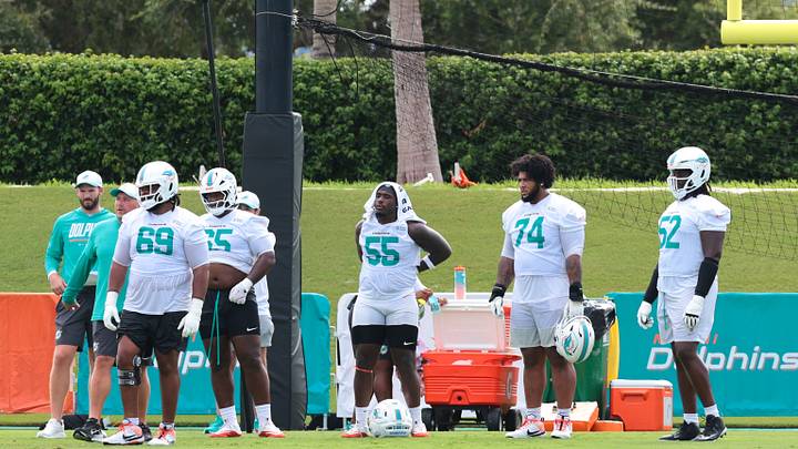 Miami Dolphins guard Jamaree Salyer (69), guard James Ester (65), center Aaron Brewer (55), offensive tackle Kadyn Proctor (74), and offensive tackle Patrick Paul (52) look on during practice at the Baptist Health Training Complex. Miami Dolphins guard Jamaree Salyer (69), guard James Ester (65), center Aaron Brewer (55), offensive tackle Kadyn Proctor (74), and offensive tackle Patrick Paul (52) look on during practice at the Baptist Health Training Complex.