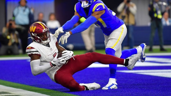 Dec 17, 2023; Inglewood, California, USA; Washington Commanders wide receiver Curtis Samuel (4) scores a touchdown ahead of Los Angeles Rams safety Quentin Lake (37) during the second half at SoFi Stadium. Mandatory Credit: Gary A. Vasquez-USA TODAY Sports Dec 17, 2023; Inglewood, California, USA; Washington Commanders wide receiver Curtis Samuel (4) scores a touchdown ahead of Los Angeles Rams safety Quentin Lake (37) during the second half at SoFi Stadium. Mandatory Credit: Gary A. Vasquez-USA TODAY Sports