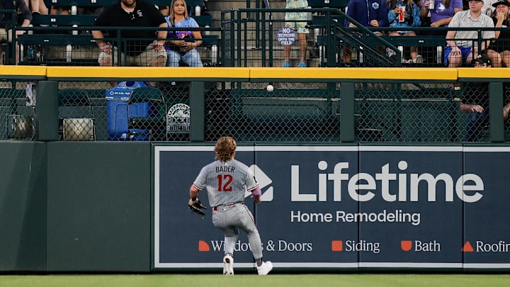 Jul 18, 2025; Denver, Colorado, USA; Minnesota Twins left fielder Harrison Bader (12) watches as the ball bounces over the fence on a ground rule double in the sixth inning against the Colorado Rockies at Coors Field. Mandatory Credit: Isaiah J. Downing-Imagn Images