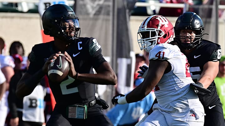 Nov 2, 2024; East Lansing, Michigan, USA; Michigan State Spartans quarterback Aidan Chiles (2) throws under pressure from Indiana Hoosiers defensive lineman Lanell Carr Jr. (41) during the first quarter at Spartan Stadium. Mandatory Credit: Dale Young-Imagn Images