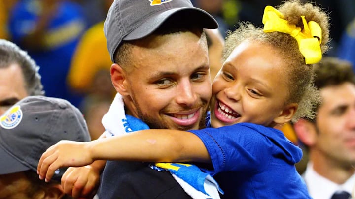 Golden State Warriors guard Stephen Curry (30) celebrates with his daughter Riley Curry after beating the Cleveland Cavaliers in game five of the 2017 NBA Finals at Oracle Arena.