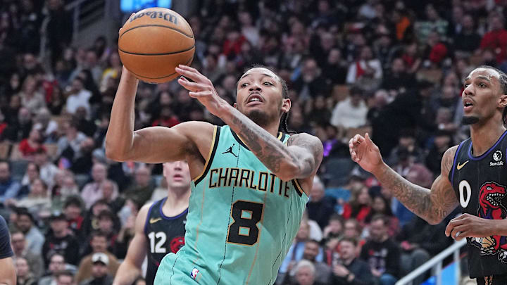 Charlotte Hornets guard Nick Smith Jr. (8) passes against Toronto Raptors guard A.J. Lawson (0) during the third quarter at Scotiabank Arena. Charlotte Hornets guard Nick Smith Jr. (8) passes against Toronto Raptors guard A.J. Lawson (0) during the third quarter at Scotiabank Arena.