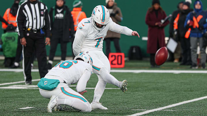Miami Dolphins place kicker Jason Sanders (7) kicks a field goal as punter Jake Bailey (16) holds during the first quarter against the New York Jets at MetLife Stadium. 