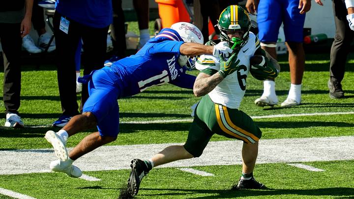 Oct 24, 2026; Lawrence, Kansas, USA; Baylor Bears wide receiver Gavin Freeman (6) is tackled by Kansas Jayhawks cornerback Lennie Brown III (17) during the second half at David Booth Kansas Memorial Stadium. Mandatory Credit: Jay Biggerstaff-Imagn Images