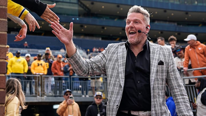 ESPN College Game Day's Pat McAfee high-fives fans as he takes the field before the game between Michigan and Texas at Michigan Stadium in Ann Arbor on Saturday, September 7, 2024.