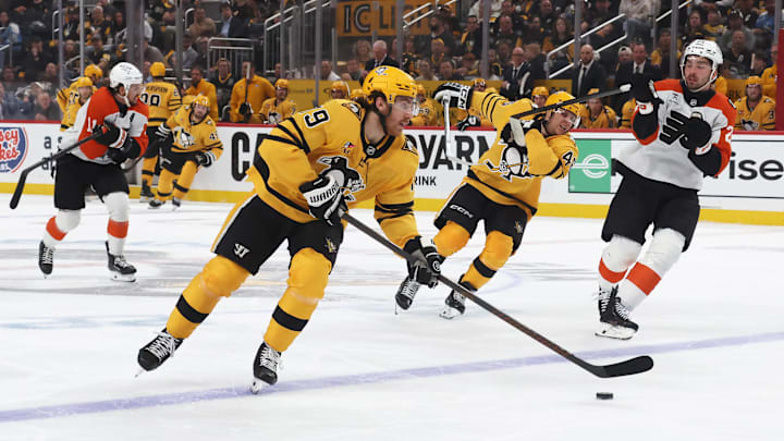 Apr 27, 2026; Pittsburgh, Pennsylvania, USA;  Pittsburgh Penguins center Connor Dewar (19) skates with the puck against the Philadelphia Flyers during the first period in game five of the first round of the 2026 Stanley Cup Playoffs at PPG Paints Arena. Mandatory Credit: Charles LeClaire-Imagn Images