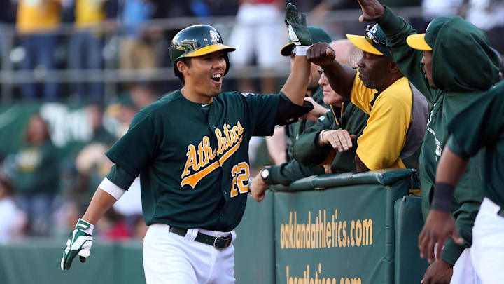 Sep 21, 2013; Oakland, CA, USA; Oakland Athletics catcher Kurt Suzuki (22) high five teammates after hitting a two run home run against the Minnesota Twins during the seventh inning at O.co Coliseum. Mandatory Credit: Kelley L Cox-Imagn Images Sep 21, 2013; Oakland, CA, USA; Oakland Athletics catcher Kurt Suzuki (22) high five teammates after hitting a two run home run against the Minnesota Twins during the seventh inning at O.co Coliseum. Mandatory Credit: Kelley L Cox-Imagn Images