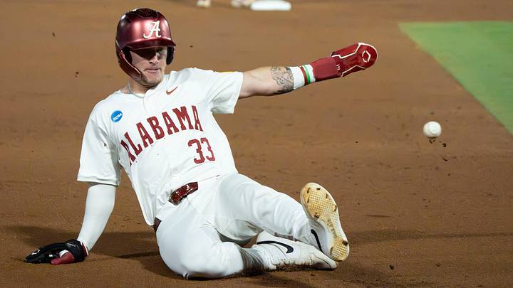 June 6, 2026; Tuscaloosa, AL, USA; Alabama base runner John Lemm (33) slides into third as the throw goes wide during the NCAA Tuscaloosa Super Regional game between Alabama and St. John’s at Sewell-Thomas Stadium. June 6, 2026; Tuscaloosa, AL, USA; Alabama base runner John Lemm (33) slides into third as the throw goes wide during the NCAA Tuscaloosa Super Regional game between Alabama and St. John’s at Sewell-Thomas Stadium.