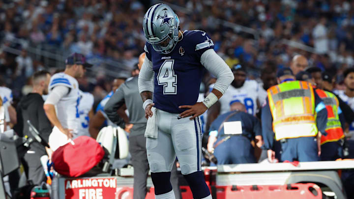 Oct 13, 2024; Arlington, Texas, USA;  Dallas Cowboys quarterback Dak Prescott (4) says a prayer for Detroit Lions injured defensive end Aidan Hutchinson (97) during the second half at AT&T Stadium. Mandatory Credit: Kevin Jairaj-Imagn Images