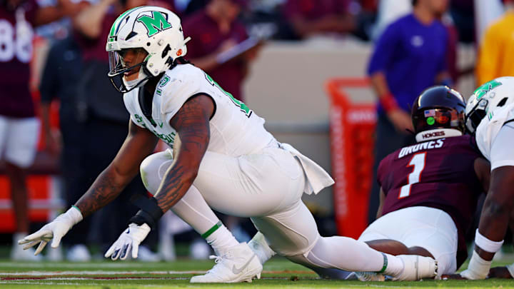 Sep 7, 2024; Blacksburg, Virginia, USA; Marshall Thundering Herd defensive lineman Mike Green (15) celebrates after sacking Virginia Tech Hokies quarterback Kyron Drones (1) during the first quarter at Lane Stadium. Mandatory Credit: Peter Casey-Imagn Images