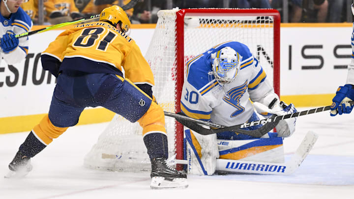Feb 2, 2026; Nashville, Tennessee, USA;  St. Louis Blues goaltender Joel Hofer (30) blocks the shot of Nashville Predators center Jonathan Marchessault (81) during the second period at Bridgestone Arena. Mandatory Credit: Steve Roberts-Imagn Images