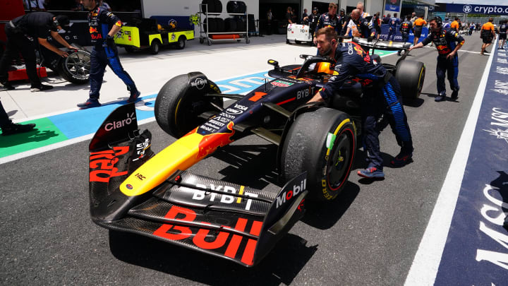 May 4, 2024; Miami Gardens, Florida, USA; Crew members push the car of Red Bull Racing driver Max Verstappen (1) back to the paddock  after the F1 Sprint Race at Miami International Autodrome. Mandatory Credit: John David Mercer-USA TODAY Sports
