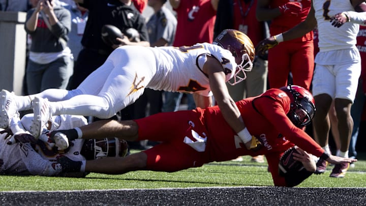 Cincinnati Bearcats quarterback Brendan Sorsby (2) dives for a touchdown as Arizona State Sun Devils defensive back Xavion Alford (2) and Arizona State Sun Devils linebacker Keyshaun Elliott (44) attempt to stop him in the first quarter of the College Football game at Nippert Stadium in Cincinnati on Saturday, Oct. 19, 2024.