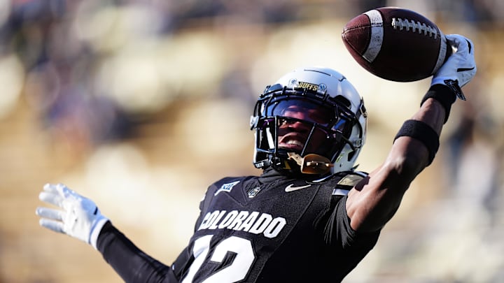 Nov 29, 2024; Boulder, Colorado, USA; Colorado Buffaloes wide receiver Travis Hunter (12) warms up before the game against the Oklahoma State Cowboys at Folsom Field. Mandatory Credit: Ron Chenoy-Imagn Images