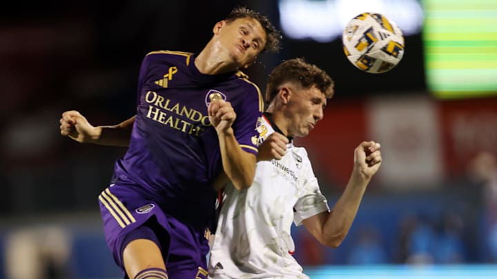 Sep 28, 2024; Frisco, Texas, USA; Orlando City defender Rodrigo Schlegel (15) and FC Dallas forward Logan Farrington (23) fight of the the ball in the second half at Toyota Stadium. Mandatory Credit: Tim Heitman-Imagn Images