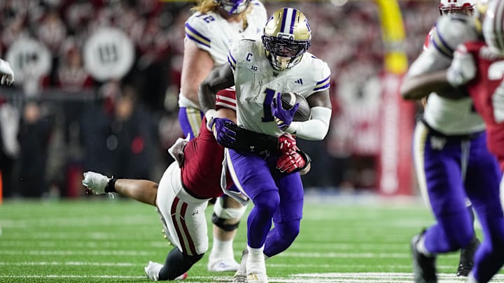 Husky running Jonah Coleman (1) is shown against Wisconsin, where he hurt his knee. 