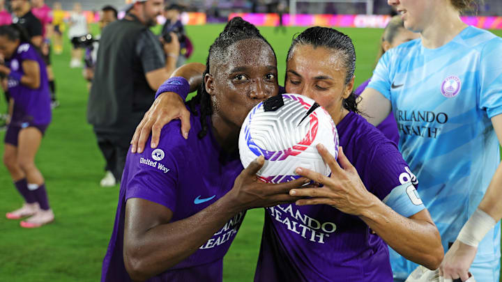 Orlando Pride forward Barbra Banda (22) and Orlando Pride forward Marta (10) kiss the game ball after the win against Utah Royals F 