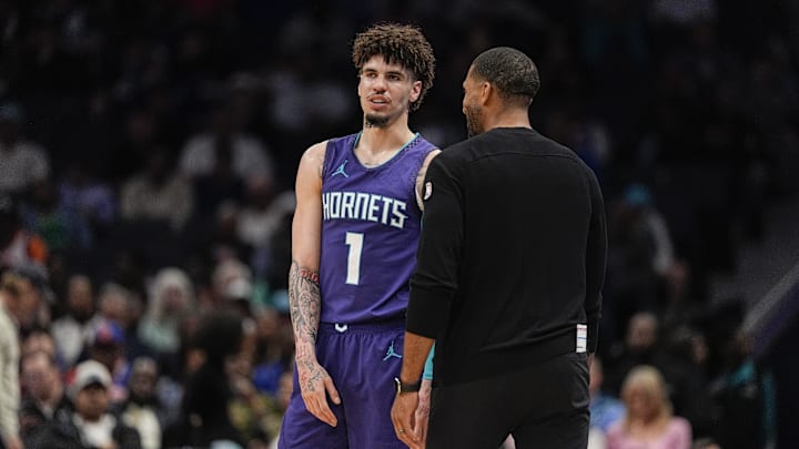 Mar 20, 2025; Charlotte, North Carolina, USA; Charlotte Hornets guard LaMelo Ball (1) talks with head coach Charles Lee  during a  free throw during the second half against the New York Knicks at Spectrum Center. Mandatory Credit: Jim Dedmon-Imagn Images