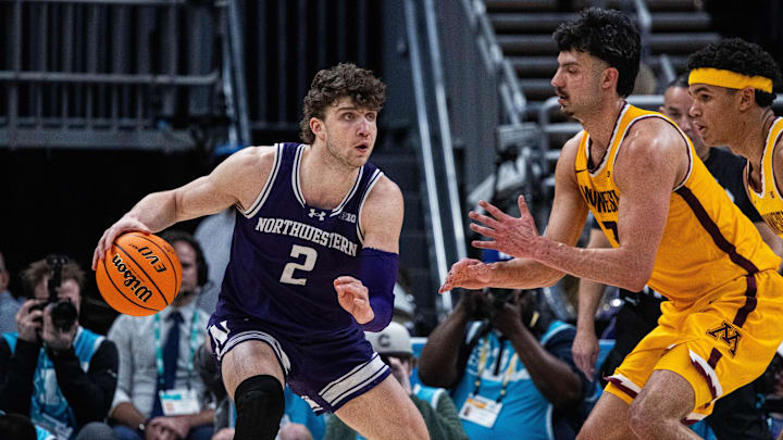 Mar 12, 2025; Indianapolis, IN, USA;  Northwestern Wildcats forward Nick Martinelli (2) dribbles the ball while Minnesota Golden Gophers forward Dawson Garcia (3) defends in the second half at Gainbridge Fieldhouse. Mandatory Credit: Trevor Ruszkowski-Imagn Images