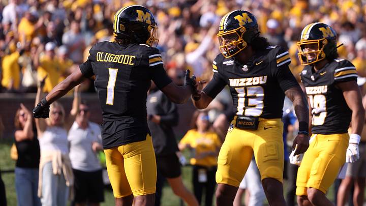 Oct 3, 2026; Columbia, Missouri, USA; Missouri Tigers wide receiver Donovan Olugbode (1) celebrates with quarterback Austin Simmons (13) after scoring a touchdown in the second quarter against the Florida Gators at Faurot Field at Memorial Stadium. Mandatory Credit: William Purnell-Imagn Images Oct 3, 2026; Columbia, Missouri, USA; Missouri Tigers wide receiver Donovan Olugbode (1) celebrates with quarterback Austin Simmons (13) after scoring a touchdown in the second quarter against the Florida Gators at Faurot Field at Memorial Stadium. Mandatory Credit: William Purnell-Imagn Images