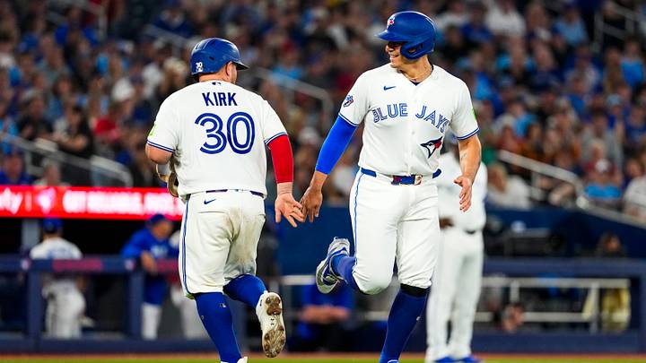 Blue Jays catcher Alejandro Kirk (30) gives pinch-runner catcher Brandon Valenzuela (59) a low five Credit: Kevin Sousa-Imagn Images