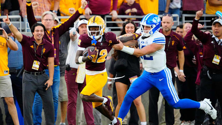BYU quarterback Jake Retzlaff (12) tackles Arizona State defensive back Javan Robinson (12) as he returns an interception during the second half of the Sun Devils' 28-23 win. BYU quarterback Jake Retzlaff (12) tackles Arizona State defensive back Javan Robinson (12) as he returns an interception during the second half of the Sun Devils' 28-23 win.