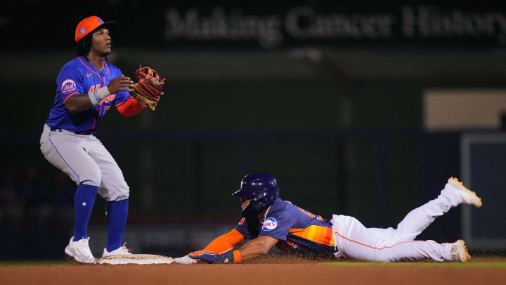 Feb 29, 2024; West Palm Beach, Florida, USA;  Houston Astros outfielder Pedro Leon steals second base as New York Mets second baseman Luisangel Acuna (73) waits for the ball in the seventh inning at The Ballpark of the Palm Beaches. Mandatory Credit: Jim Rassol-USA TODAY Sports