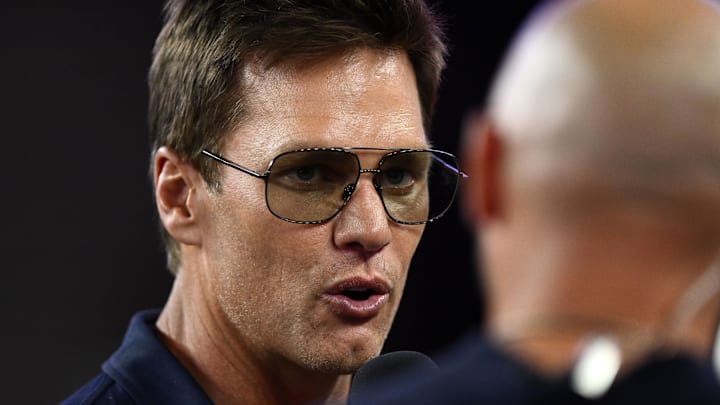 Aug 8, 2025; Foxborough, Massachusetts, USA; Retired Hall of Fame New England Patriot player Tom Brady talks with Brian Hoyer during the first half of a game against the Washington Commanders at Gillette Stadium. 