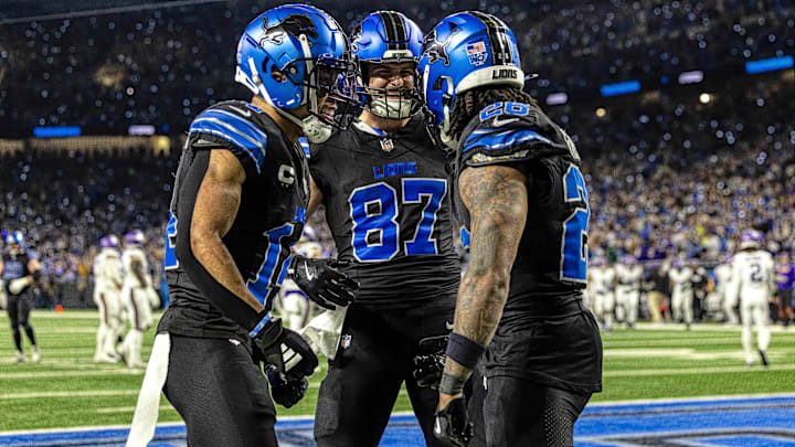 Detroit Lions running back Jahmyr Gibbs (26) celebrates his touchdown against the Minnesota Vikings with wide receiver Amon-Ra St. Brown (14) and tight end Sam LaPorta (87) during the second half at Ford Field.