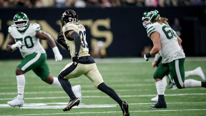 Dec 21, 2025; New Orleans, Louisiana, USA;  New Orleans Saints safety Jonas Sanker (33) runs after an interception against the New York Jets during the fourth quarter at Caesars Superdome. Mandatory Credit: Matthew Hinton-Imagn Images