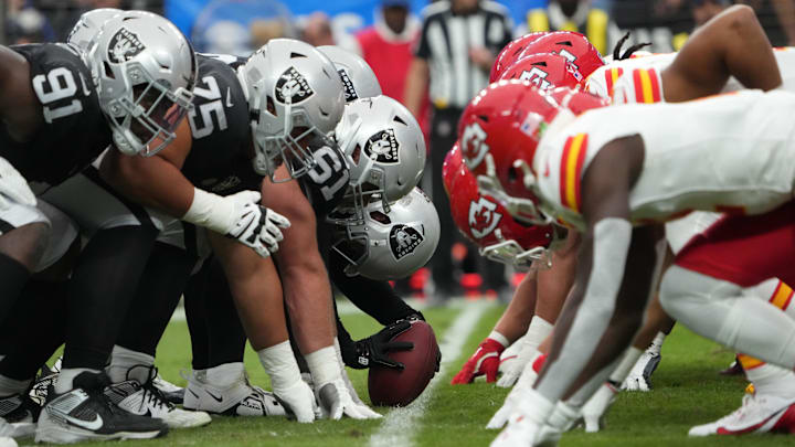 Oct 27, 2024; Paradise, Nevada, USA; Helmets at the line of scrimmage as Las Vegas Raiders long snapper Jacob Bobenmoyer (50) snaps the ball against the Kansas City Chiefs in the first half at Allegiant Stadium. Mandatory Credit: Kirby Lee-Imagn Images