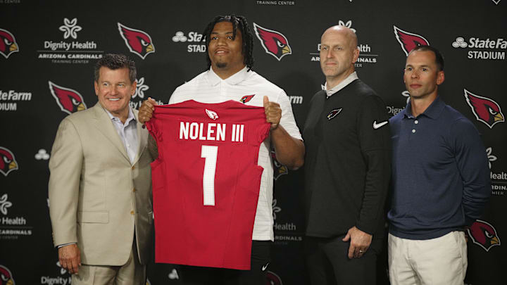 Cardinals defensive lineman Walter Nolen stands and holds his jersey with owner Michael Bidwill (left to right), general manager Monti Ossenfort and head coach Jonathan Gannon during his introductory news conference inside the Arizona Cardinals training facility on April 25, 2025, in Tempe.
