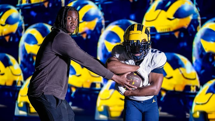Michigan QB Bryce Underwood hands the ball off to new Michigan RB commit Savion Hiter Michigan QB Bryce Underwood hands the ball off to new Michigan RB commit Savion Hiter
