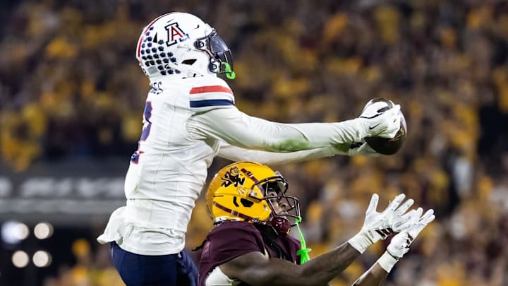 Nov 28, 2025; Tempe, Arizona, USA; Arizona Wildcats defensive back Treydan Stukes (2) intercepts the ball against Arizona State Sun Devils wide receiver Jaren Hamilton (16) in the second half during the 99th Territorial Cup at Mountain America Stadium. Mandatory Credit: Mark J. Rebilas-Imagn Images Nov 28, 2025; Tempe, Arizona, USA; Arizona Wildcats defensive back Treydan Stukes (2) intercepts the ball against Arizona State Sun Devils wide receiver Jaren Hamilton (16) in the second half during the 99th Territorial Cup at Mountain America Stadium. Mandatory Credit: Mark J. Rebilas-Imagn Images