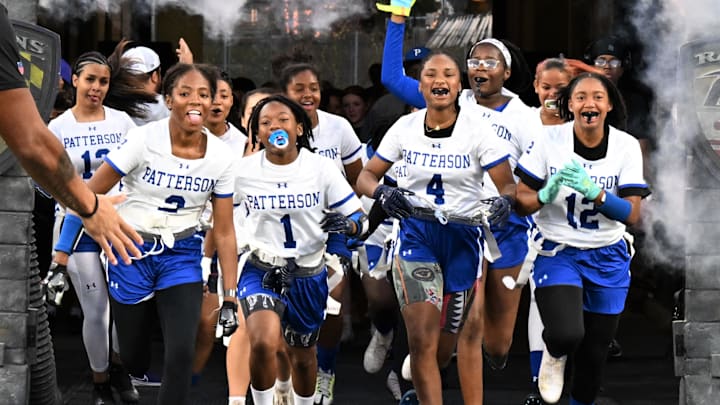 With the same excitement and flash usually reserved for the NFL's Baltimore Ravens, the Patterson girls flag football team races from the tunnel at M&T Bank Stadium in Baltimore to compete in the state championship event hosted by the Ravens.