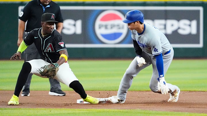 Los Angeles Dodgers Shohei Ohtani (17) steals second base against Arizona Diamondbacks shortstop Geraldo Perdomo (2) in the seventh inning at Chase Field on Sept. 2, 2024, in Phoenix.