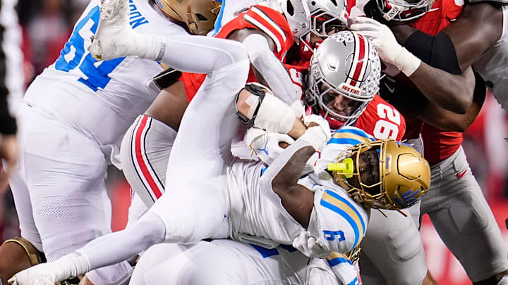 Ohio State Buckeyes defensive end Caden Curry (92) tackles UCLA Bruins running back Anthony Woods (6) during the NCAA football game at Ohio Stadium in Columbus on Nov. 15, 2025. Ohio State won 48-10.