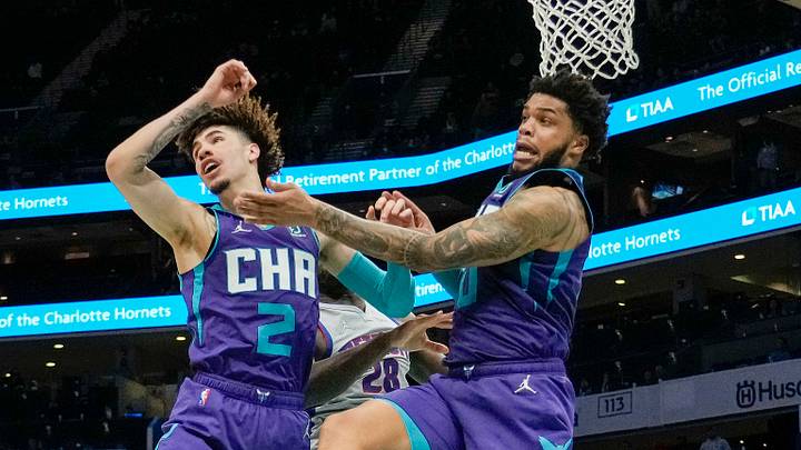 Charlotte Hornets guard LaMelo Ball (2) and forward Miles Bridges (0) react to a loose ball against the Detroit Pistons during the second half at the Spectrum Center. Charlotte Hornets guard LaMelo Ball (2) and forward Miles Bridges (0) react to a loose ball against the Detroit Pistons during the second half at the Spectrum Center.