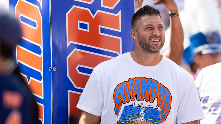 Aug 31, 2024; Gainesville, Florida, USA; Former Florida Gators quarterback Tim Tebow (15) watches team introductions against the Miami Hurricanes before the game at Ben Hill Griffin Stadium. Mandatory Credit: Matt Pendleton-Imagn Images